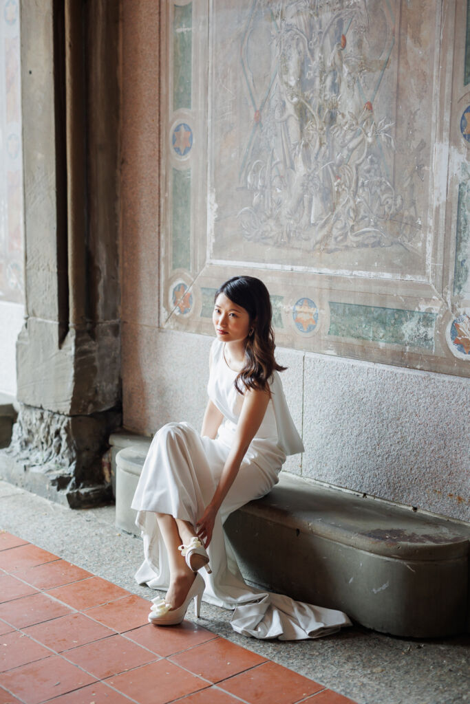 ニューヨークの前撮り/フォトウェディング|ベセスダテラスの壁画前で腰かける花嫁。