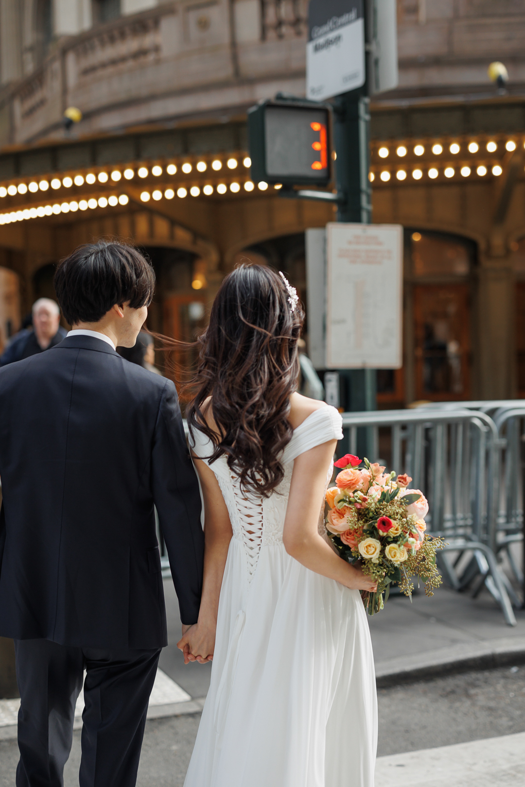 ニューヨークのウェディングフォト/前撮り|グランドセントラル駅の屋外を歩く花嫁と花婿。