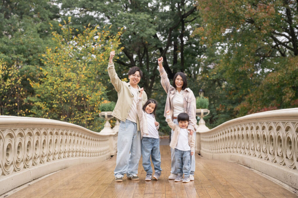 ニューヨークでファミリーフォト/ボウブリッジに立つご家族４人。