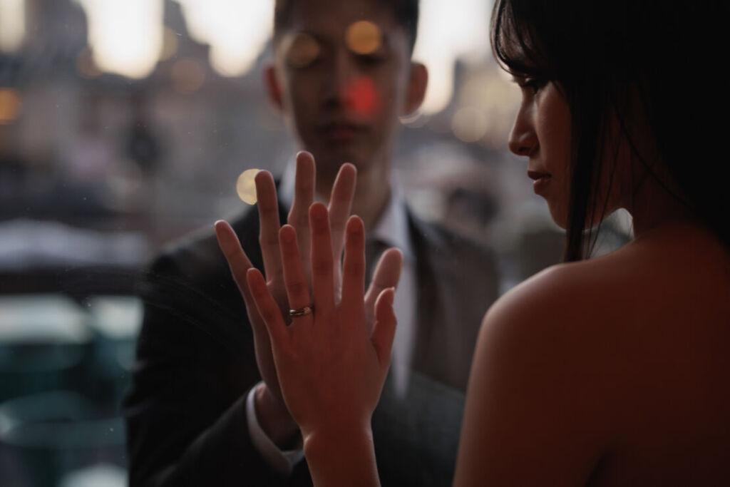 ニューヨークで後撮り/フォトウェディング|窓越しに手を合わせる花嫁と花婿。