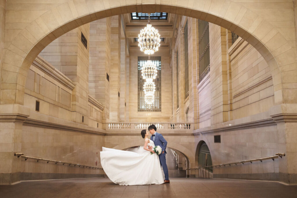 ニューヨークでフォトウェディング|前撮り/グランドセントラル駅に立つ花嫁さまと花婿さま。